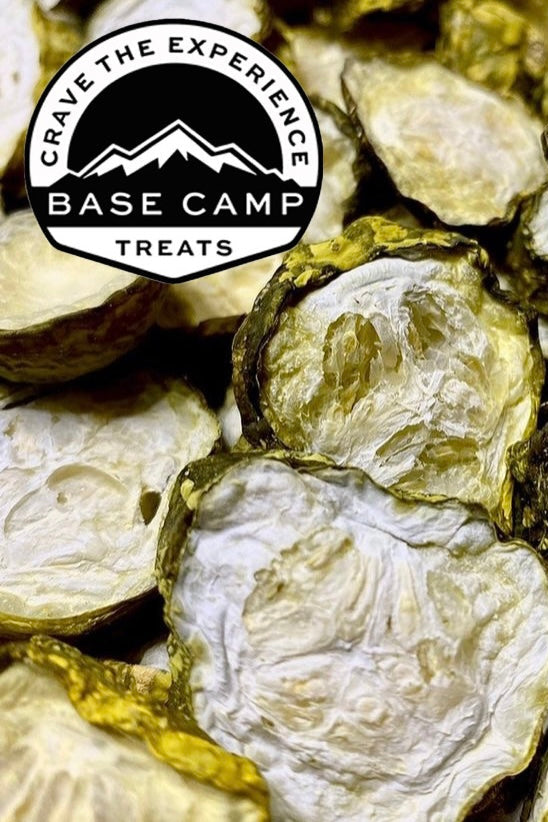 Close-up of dried pickles with 'Base Camp Treats' logo in the corner.
