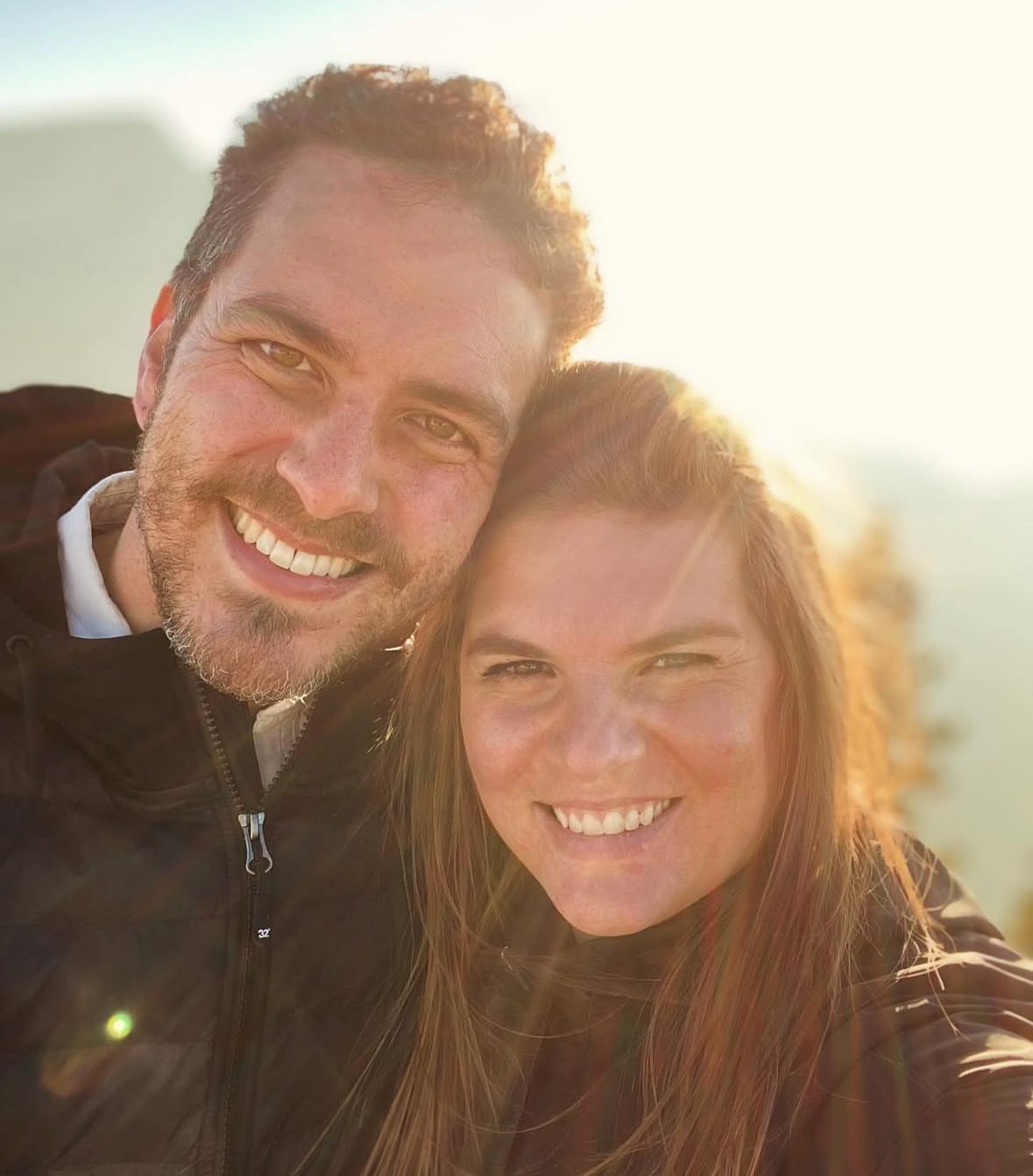 Chris and Melissa Nehring, founders and owners of Base Camp Treats, smiling outdoors