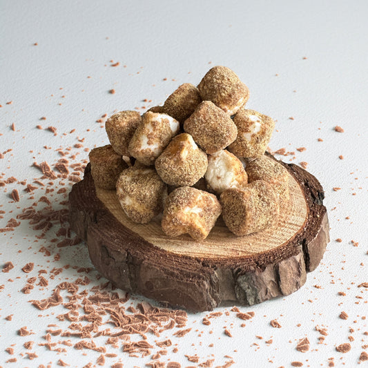 Base Camp Treats Freeze Dried Mini S'mores on a wooden coaster on a white background